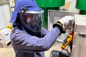 Steve Thompson in PPE testing a piece of equipment