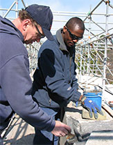 Employees replacing stonework