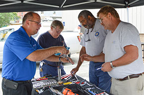 Employees visiting a tradeshow tent